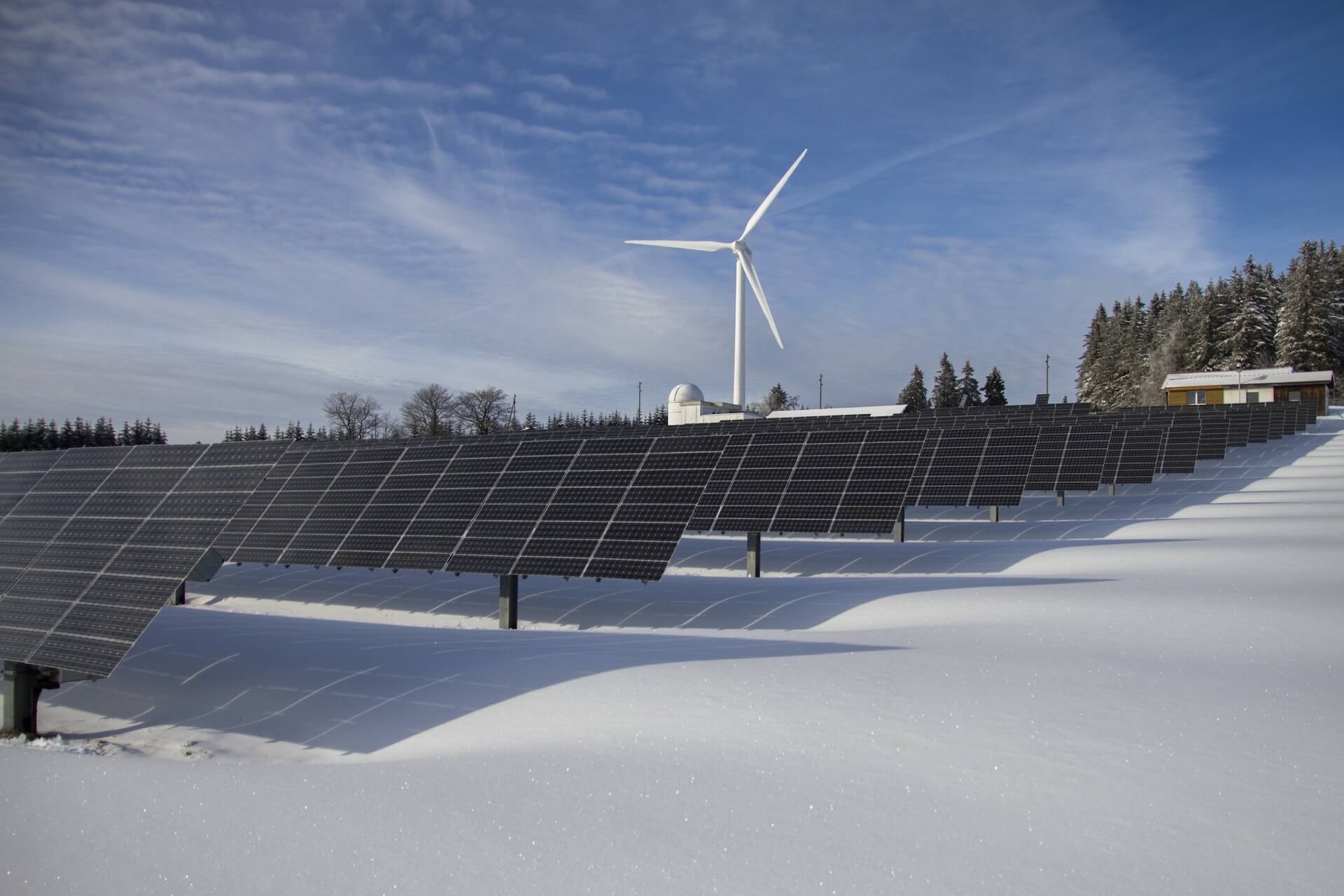 Farmland mounting system: Solar Panel Park and windmill in winter snowing environment